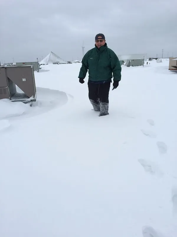 Skip Schiappa walking across a snow-covered roof